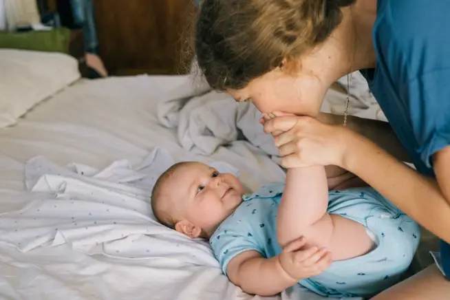 Mum kissing a baby's feet