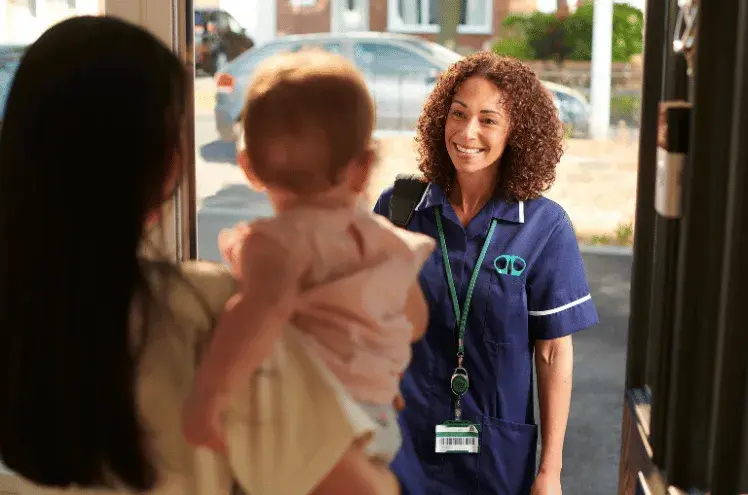 a health visitor visiting a mum and baby